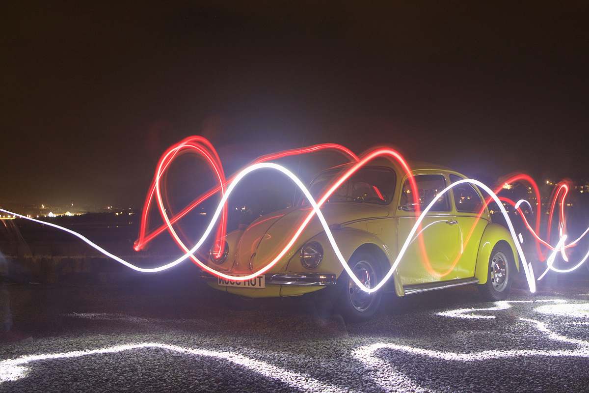 car backgrounds yellow Volkswagen Beetle in time lapse photography during night car wallpapers